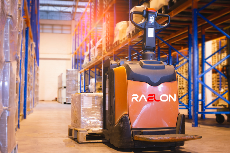 Operator moving pallets with an electric pallet jack in a warehouse