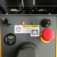 Control panel with warning labels, red button, and digital display on a machine.
