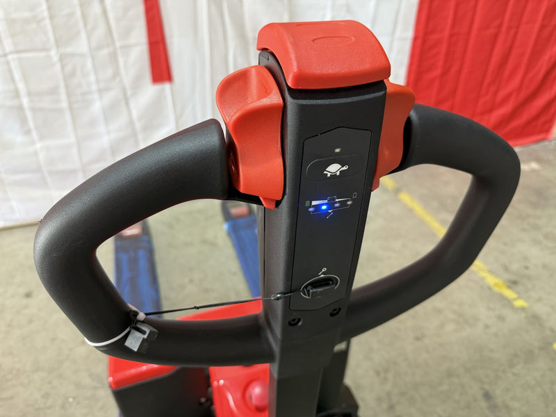 Close-up of the Raelon CBD15W-II control handle showing the red butterfly levers, the turtle speed button and the battery gauge lit blue