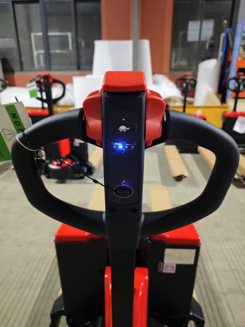 Close-up of the CBD20W-II control handle from the operator's position, showing the turtle speed icon, lit battery indicator, key switch and red butterfly throttle