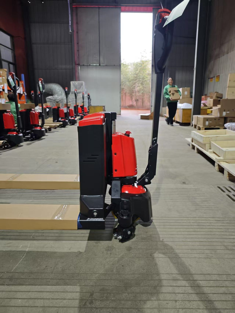 Side view of a Raelon CBD20W-II electric pallet jack with the handle upright, showing the black battery housing, red drive motor cover and drive wheel unit